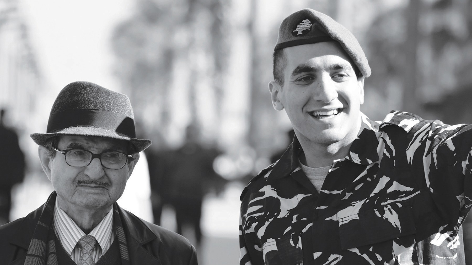 A member of Lebanon's ISF with an elderly man in a hat