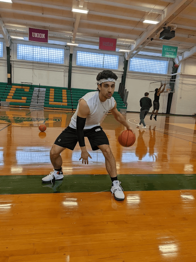 Frank playing basketball on an indoor court