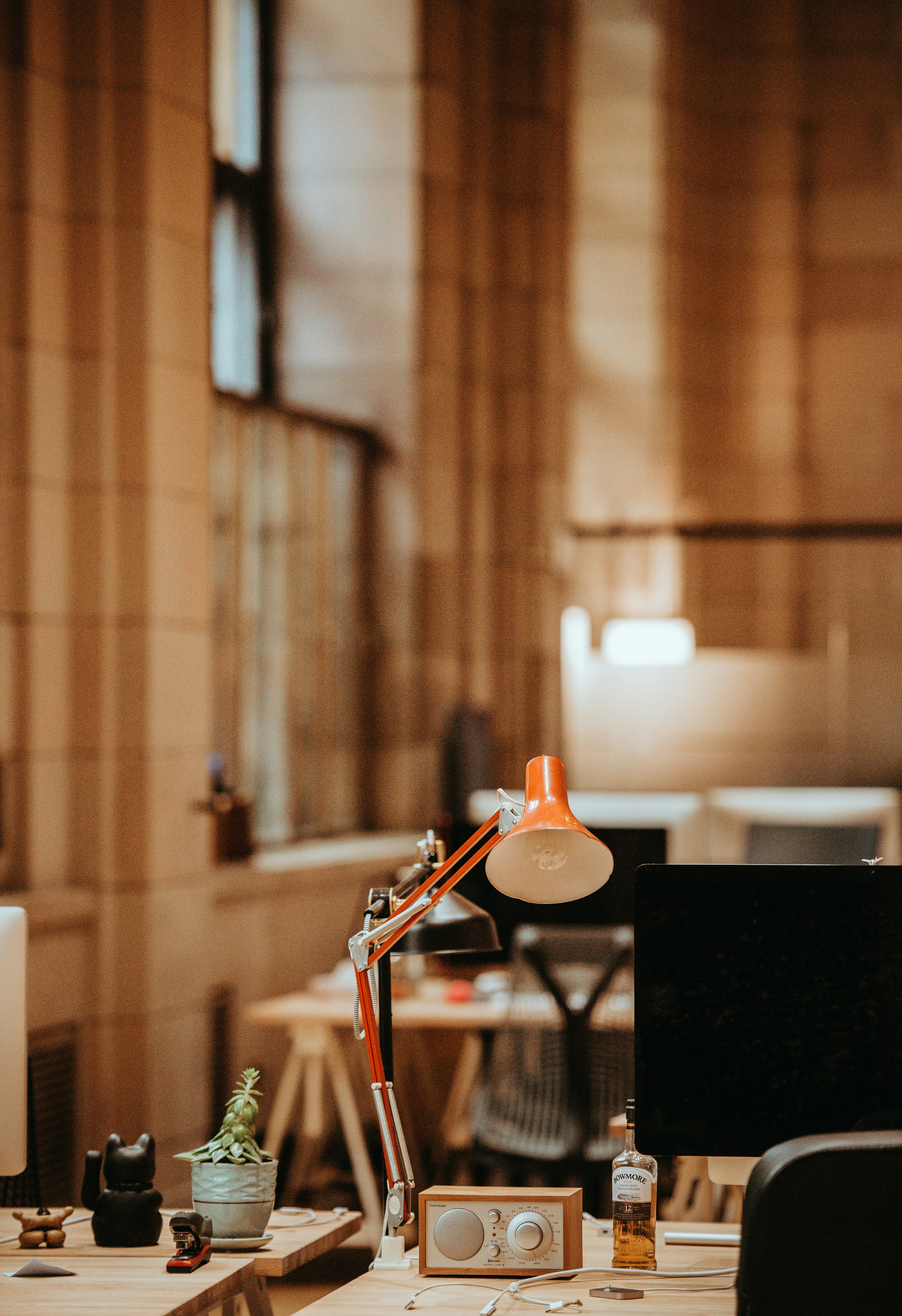 An orange lamp on a table in an office