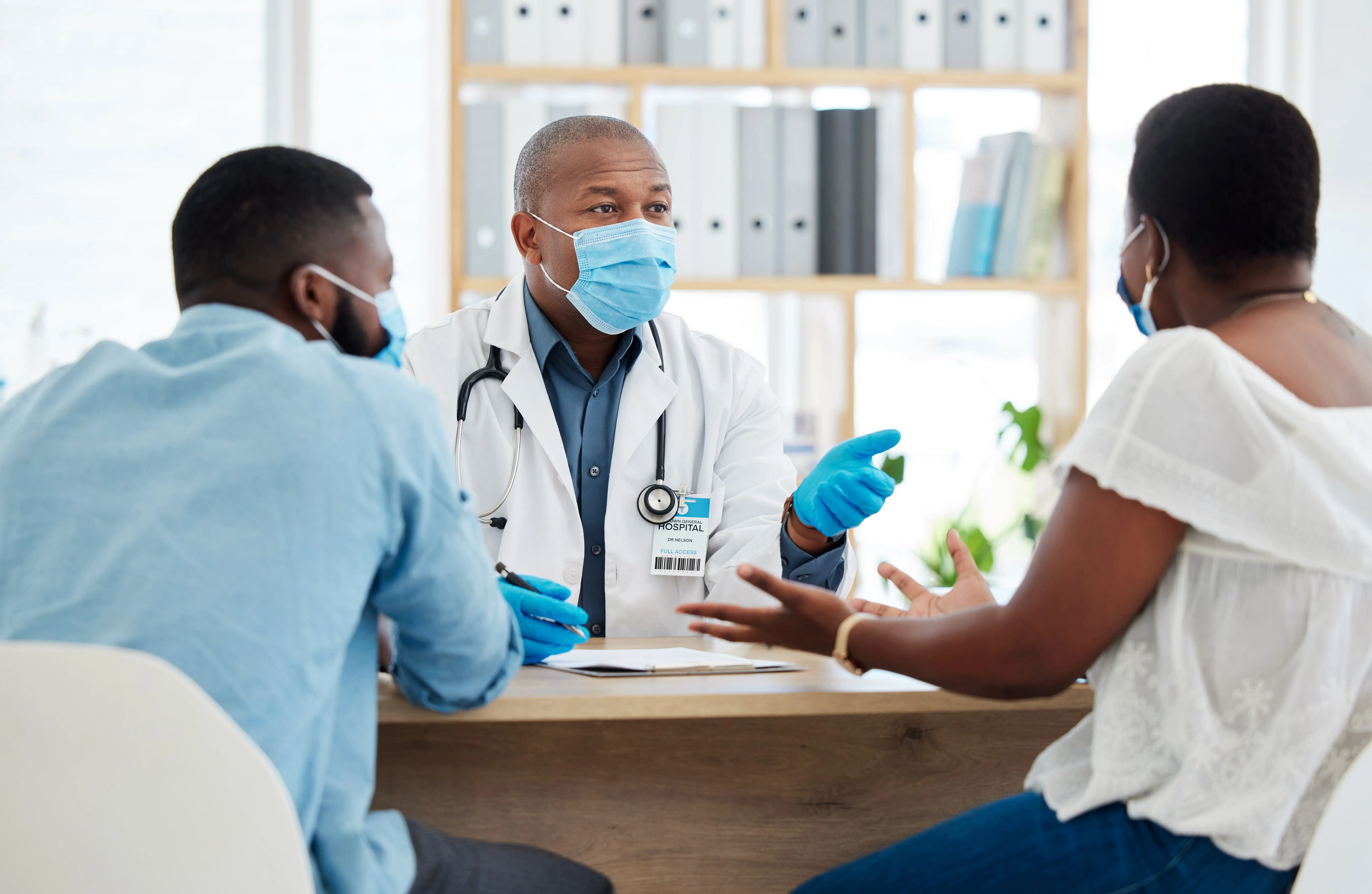 Orthopaedic consultation between a specialist and patients discussing treatment options