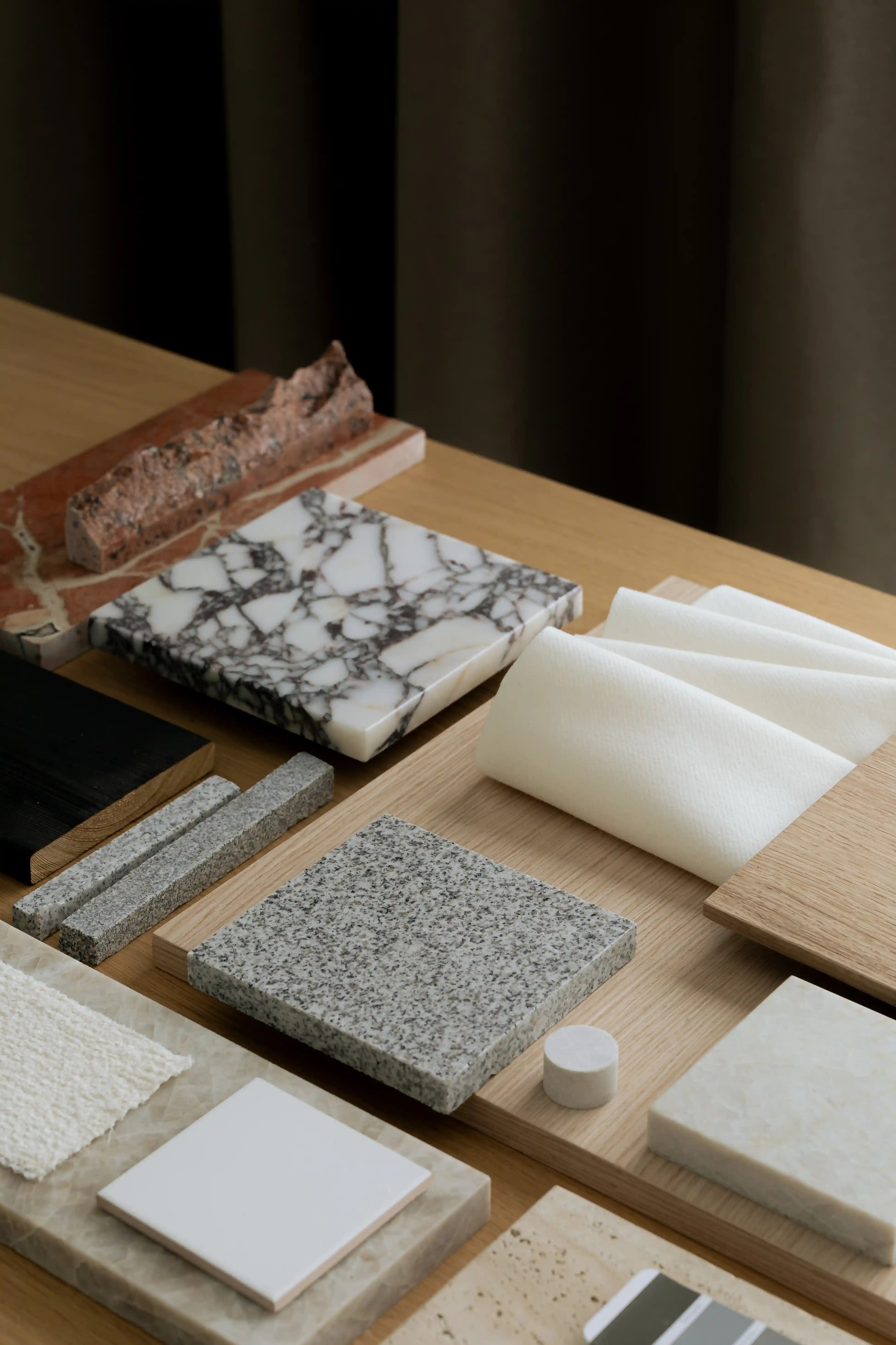 Interior design mood board with fabric samples and stone textures.