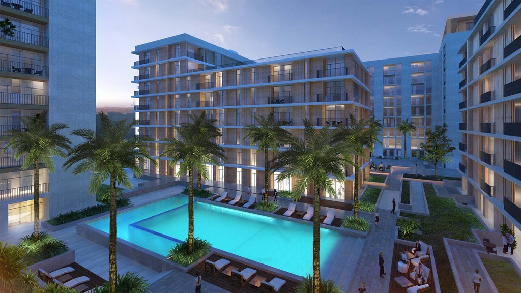 A swimming pool encircled by lush palm trees at Park Point, creating a tropical oasis atmosphere.