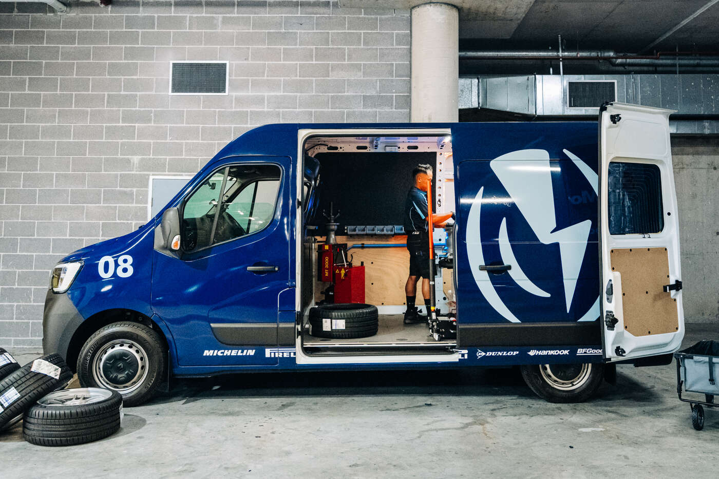 Person wearing orange sunglasses with dramatic orange and red lighting effects creating an artistic portrait