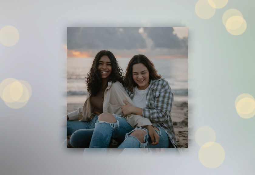 Photo engagement announcement featuring happy couple and dreamy bokeh effect overlay