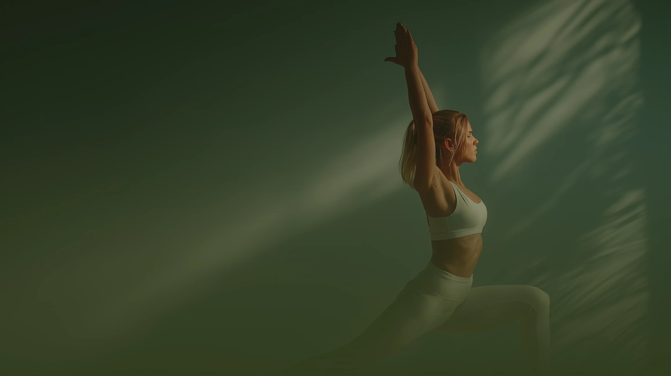 Woman practicing yoga in a calm studio with soft natural light.
