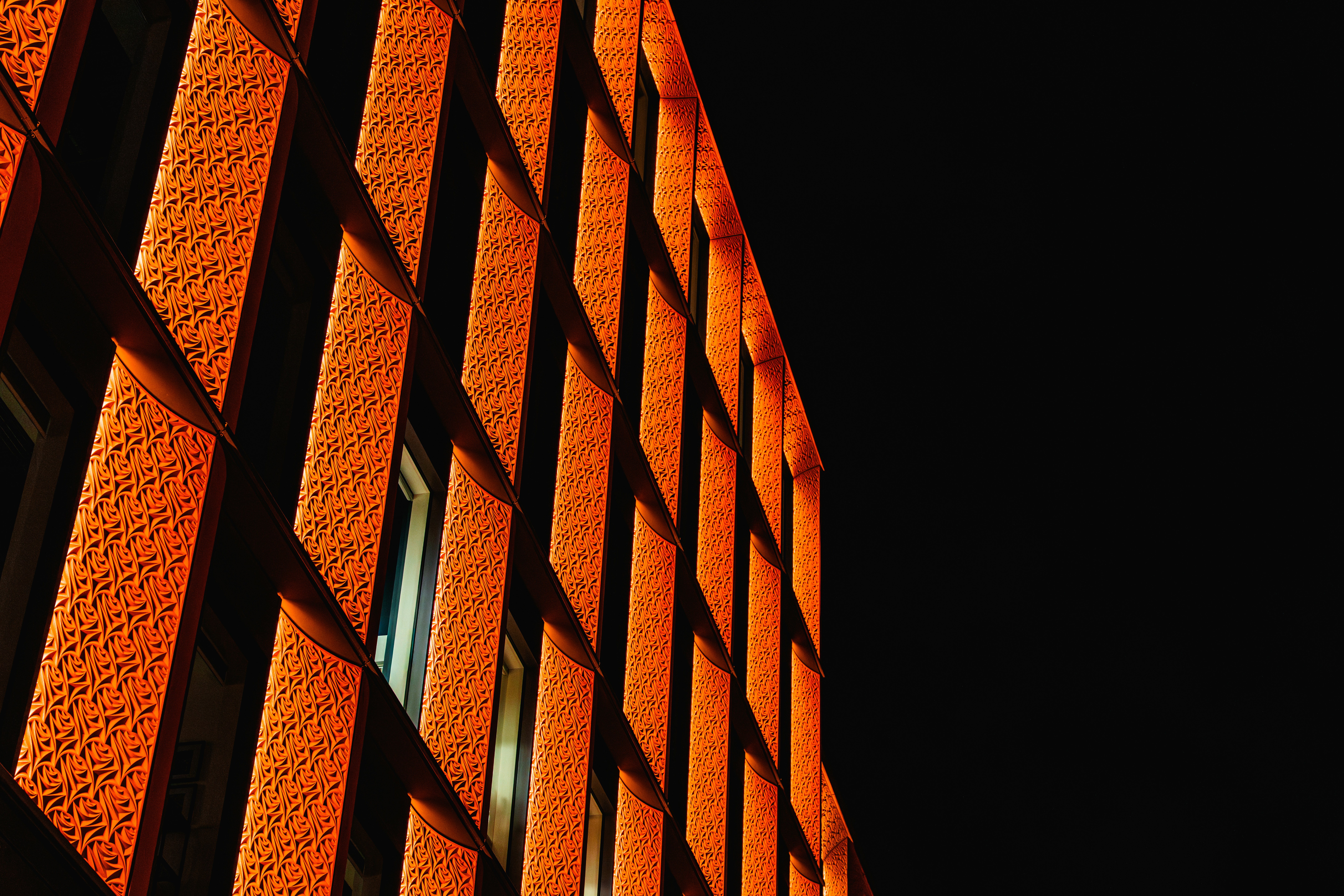 Orange building facade with strong geometric shadows