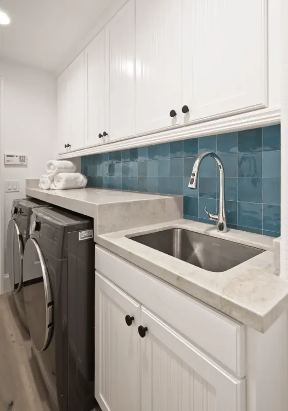 Portrait image focusing on the living room cabinet and fireplace details, accentuating the design and functionality in the Dana Point Remodel. Photo by Todd Huge.