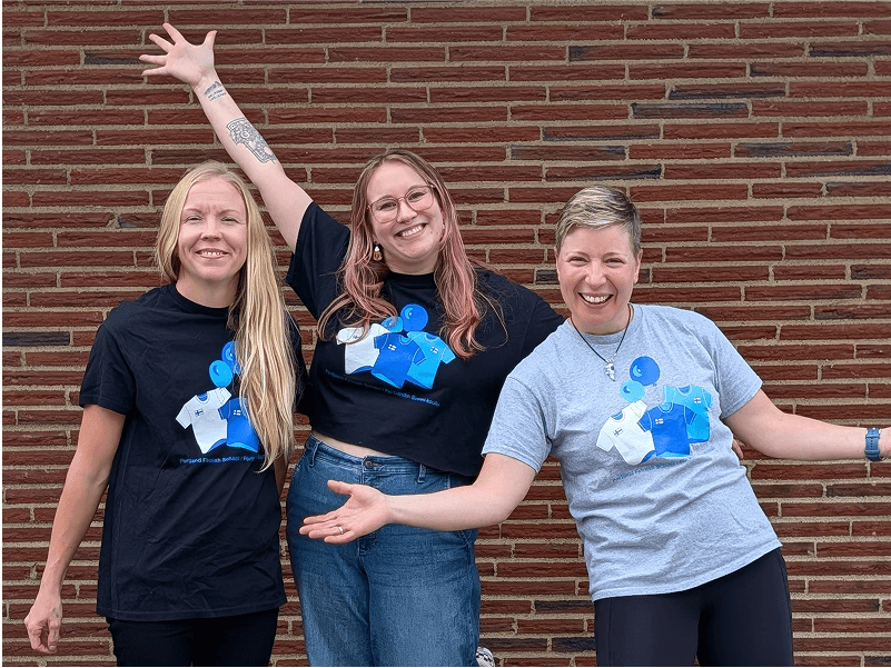 Photo of Finnish School teachers wearing matching shrits with illustrations of (more) shirts and balloons.