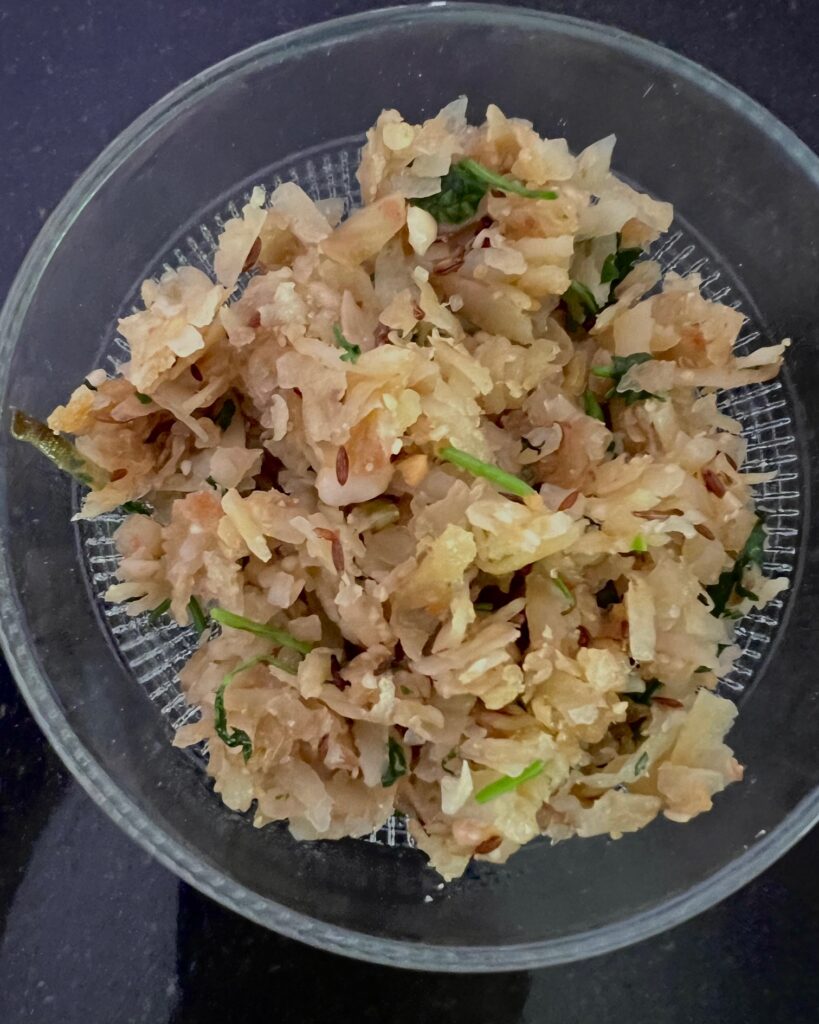 Ratalyache Kees or Spiced grated sweet potato in a bowl.