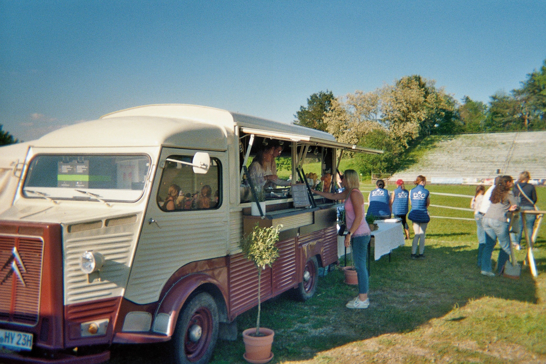 man and woman both laughing by tree during daytime