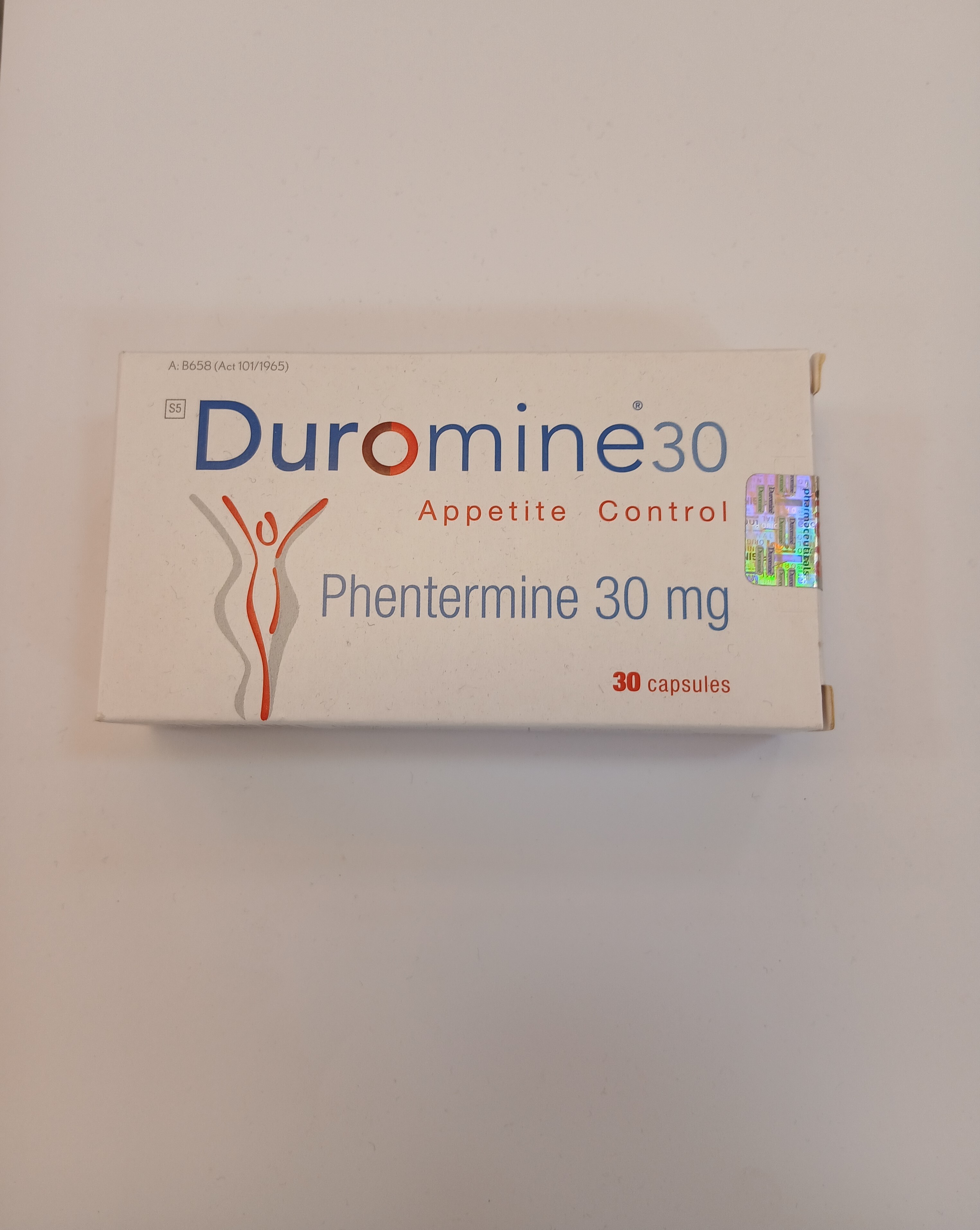 White cardboard box packaging displays text reading "Phentermine 30 mg" and "Appetite Control" with an illustration of a figure, containing 30 capsules inside.