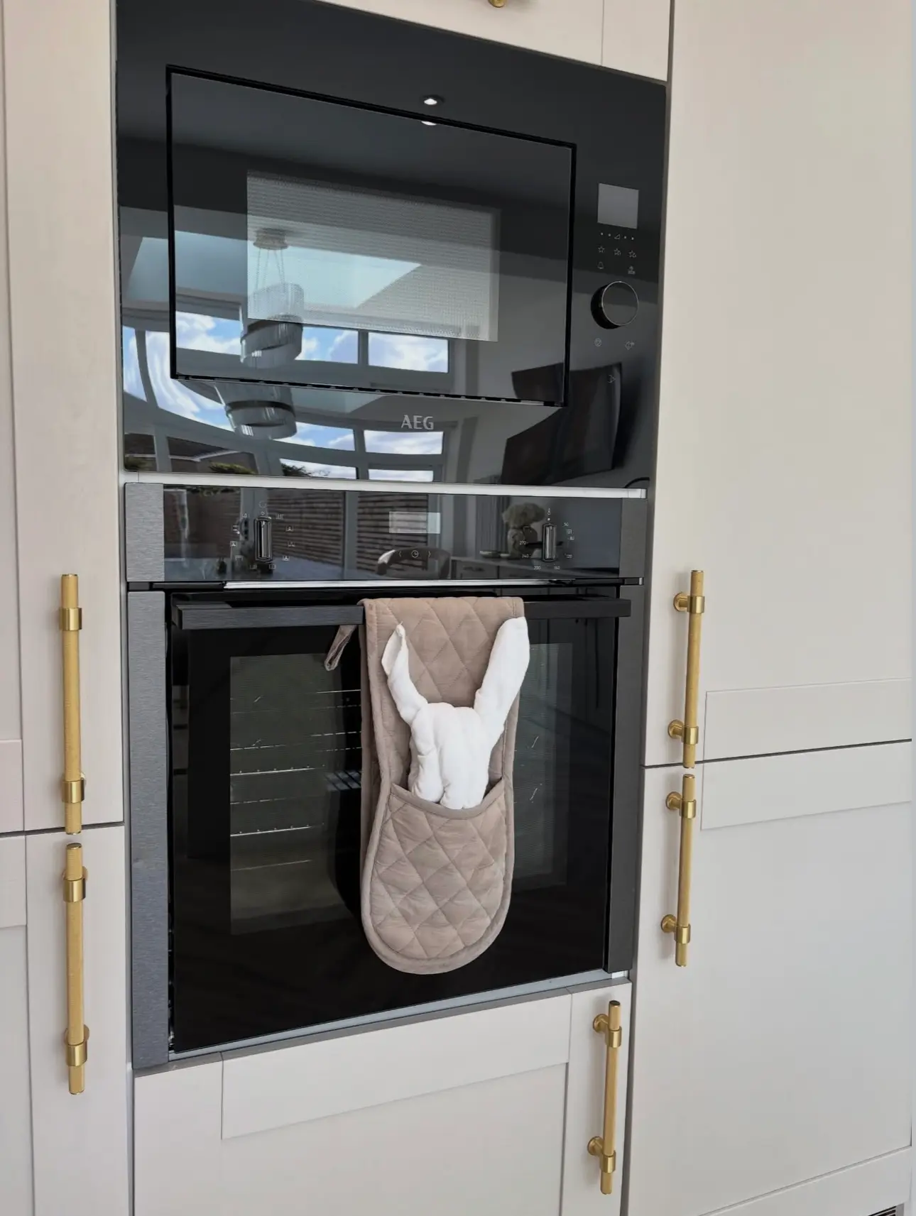 Reflective, streak-free kitchen appliances showcasing a custom-folded towel bunny, displaying the boutique care of a Gilbert, Arizona house cleaning service.