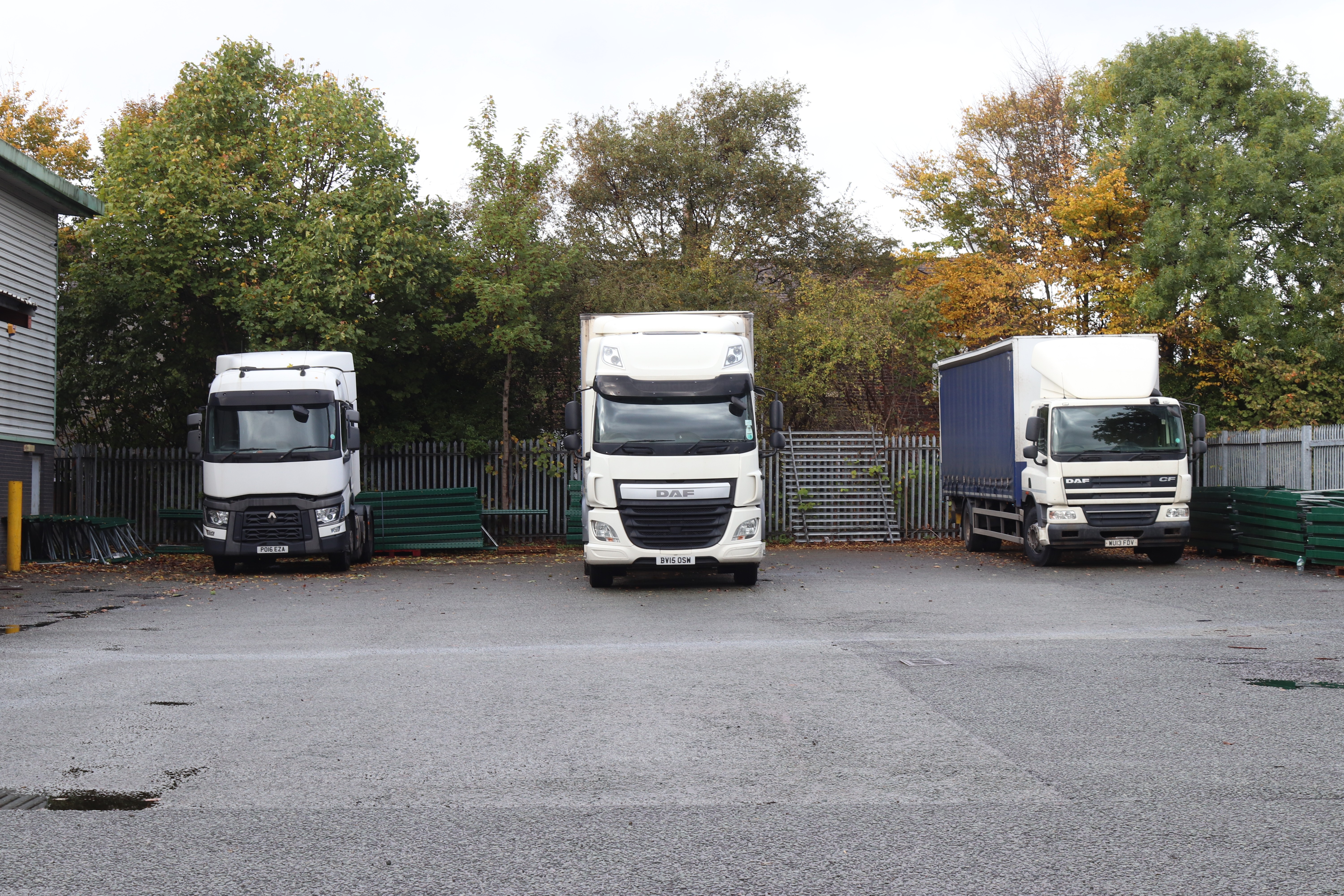 image of three Large HGV trucks all parked in a loading bay