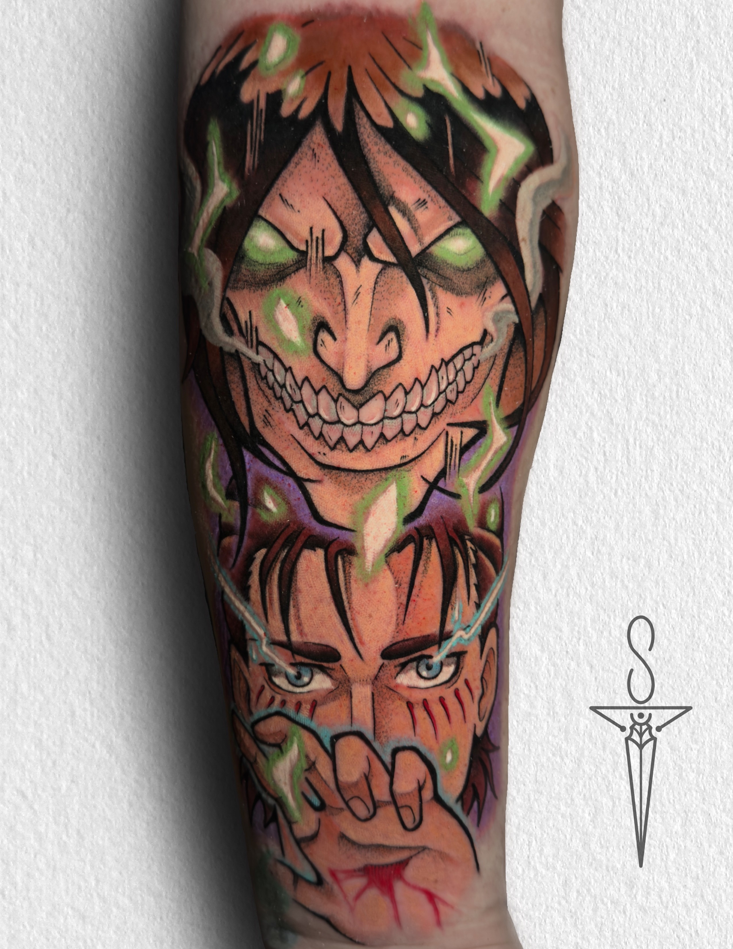 A vibrant tattoo of a chainsaw-like creature on a person's forearm. The tattoo is detailed with shades of orange, black, teal, and red.