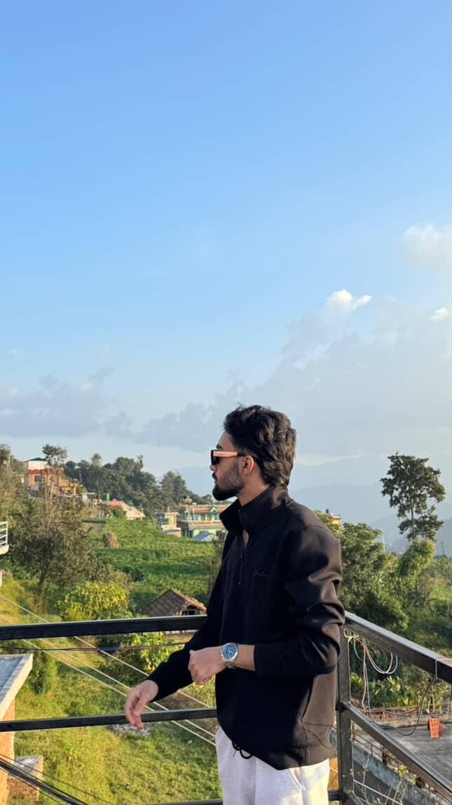Nischal Poudel with flowy hairs with a great background