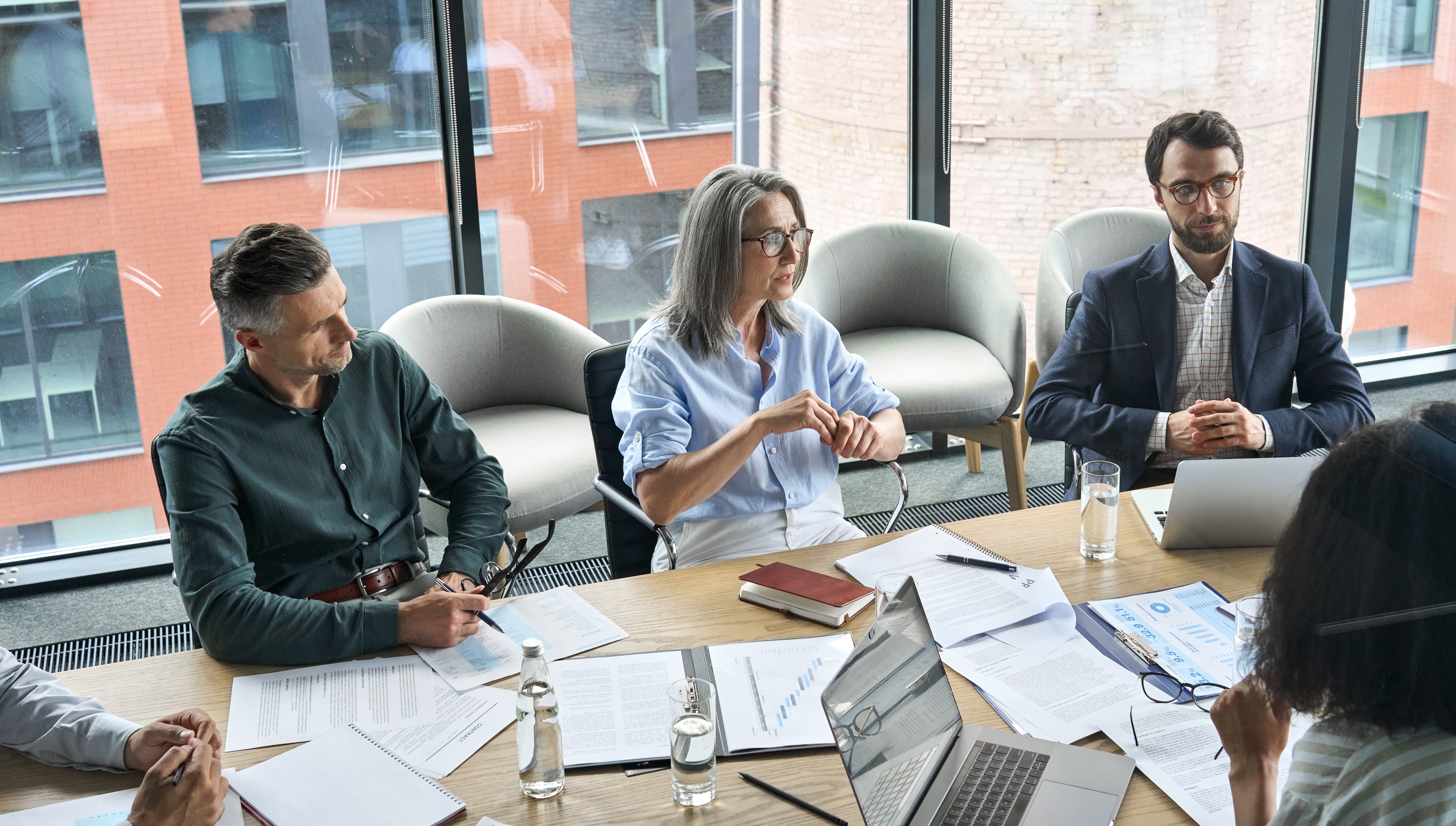 a group of people sitting around a conference table