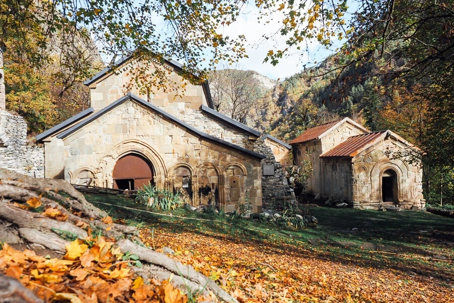 Ancient monastery in autumn forest