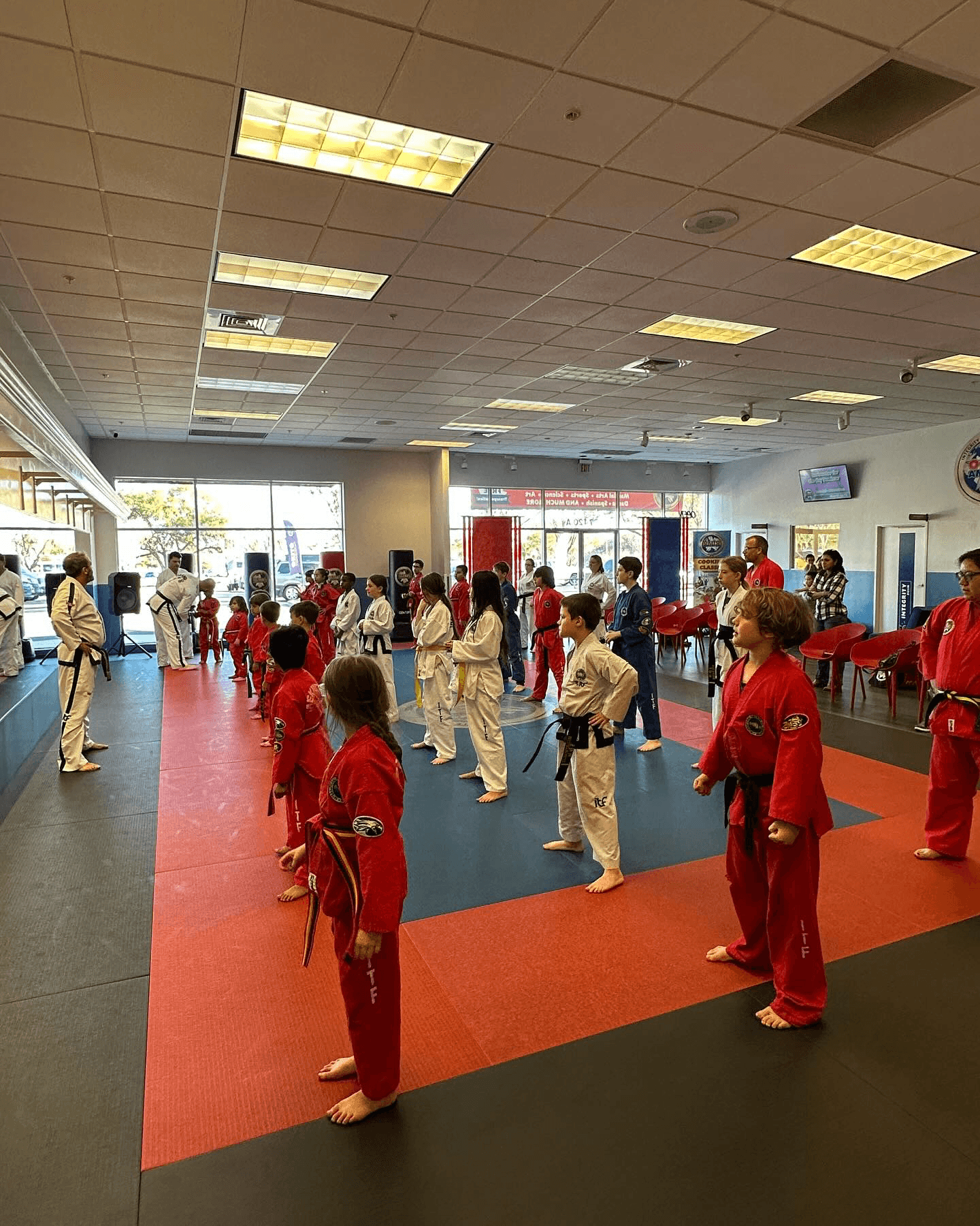Groups attendees looking at the instructor of a Taekwondo class.