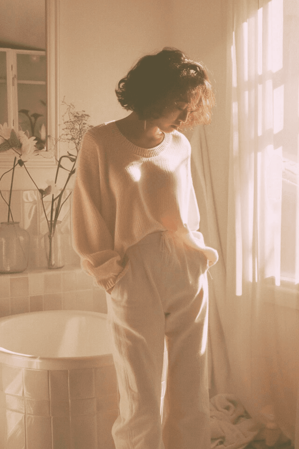 Postpartum mother standing in bathroom looking down, experiencing pelvic discomfort and urinary incontinence in early recovery