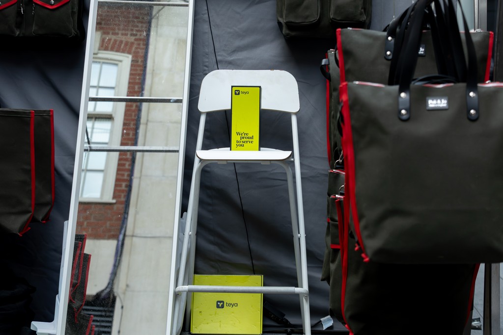 Local UK bakery owner holding a Teya card machine showing a successful Monthly Bread Subscription payment