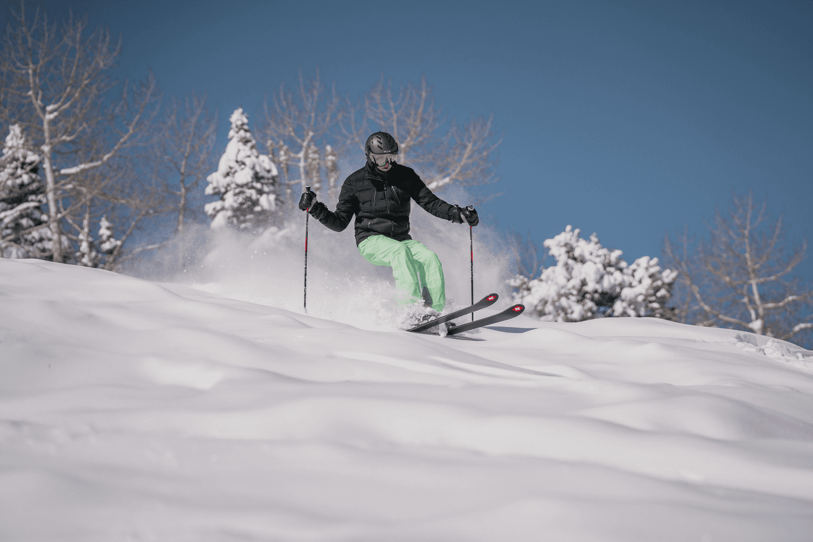 Aspen ski photographer following a skier through powder