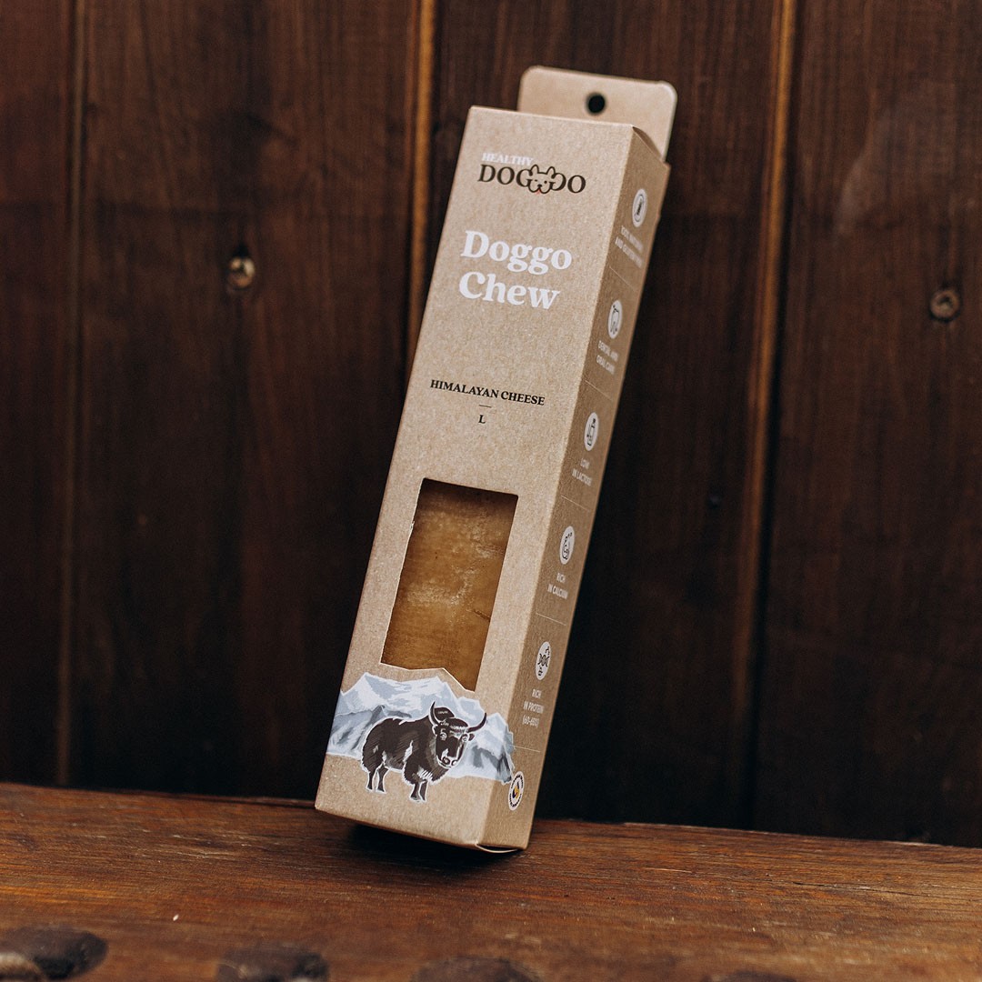 Modern home office setup with a monitor, ergonomic chair, keyboard, and indoor plants near a window with blinds.