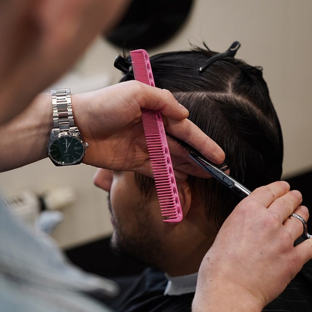 Open pizza box next to glass of wine