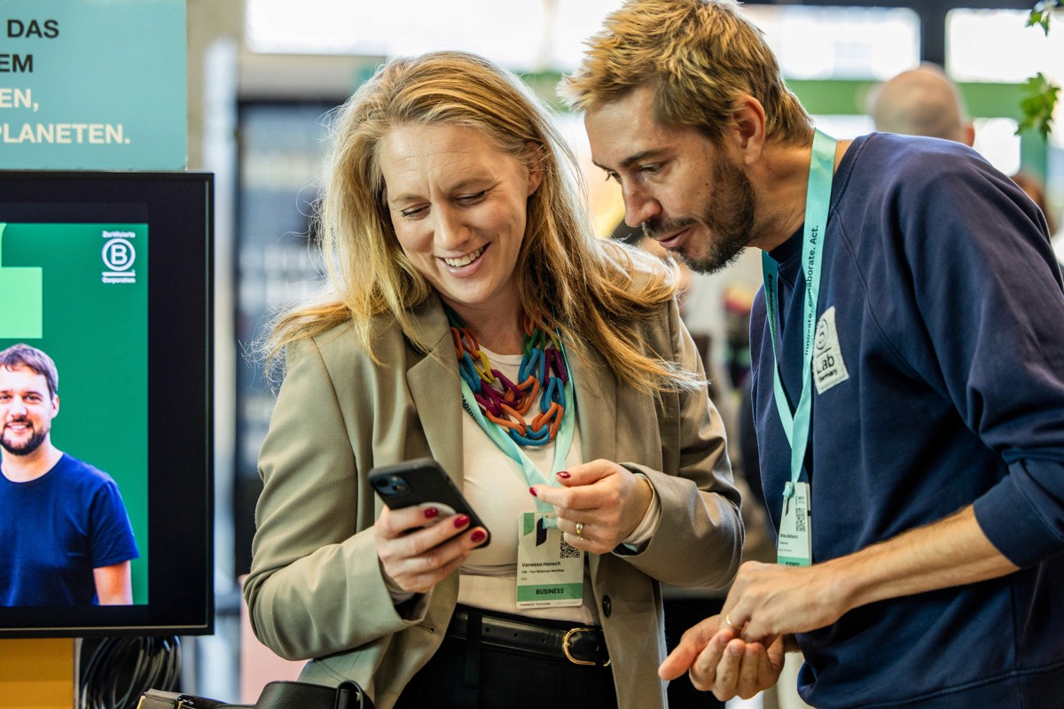 Zwei Geschäftspersonen stehen an einem Konferenztisch und diskutieren intensiv