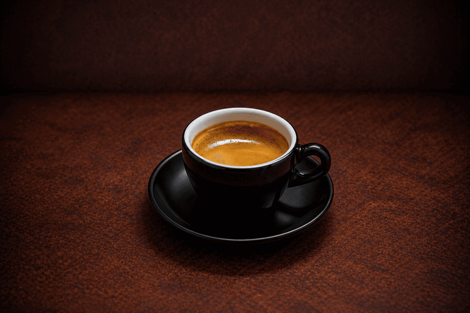 Double Shot Espresso in a black ceramic cup at Café Sherpa's café in Brookfield, WI. Bold dark-roast with smooth chocolate notes and a rich finish.