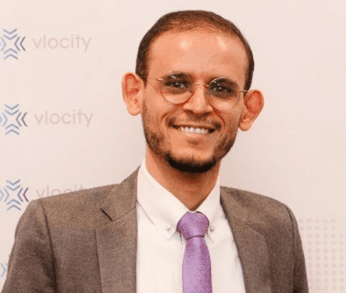 smiling woman wearing white and black pinstriped collared top