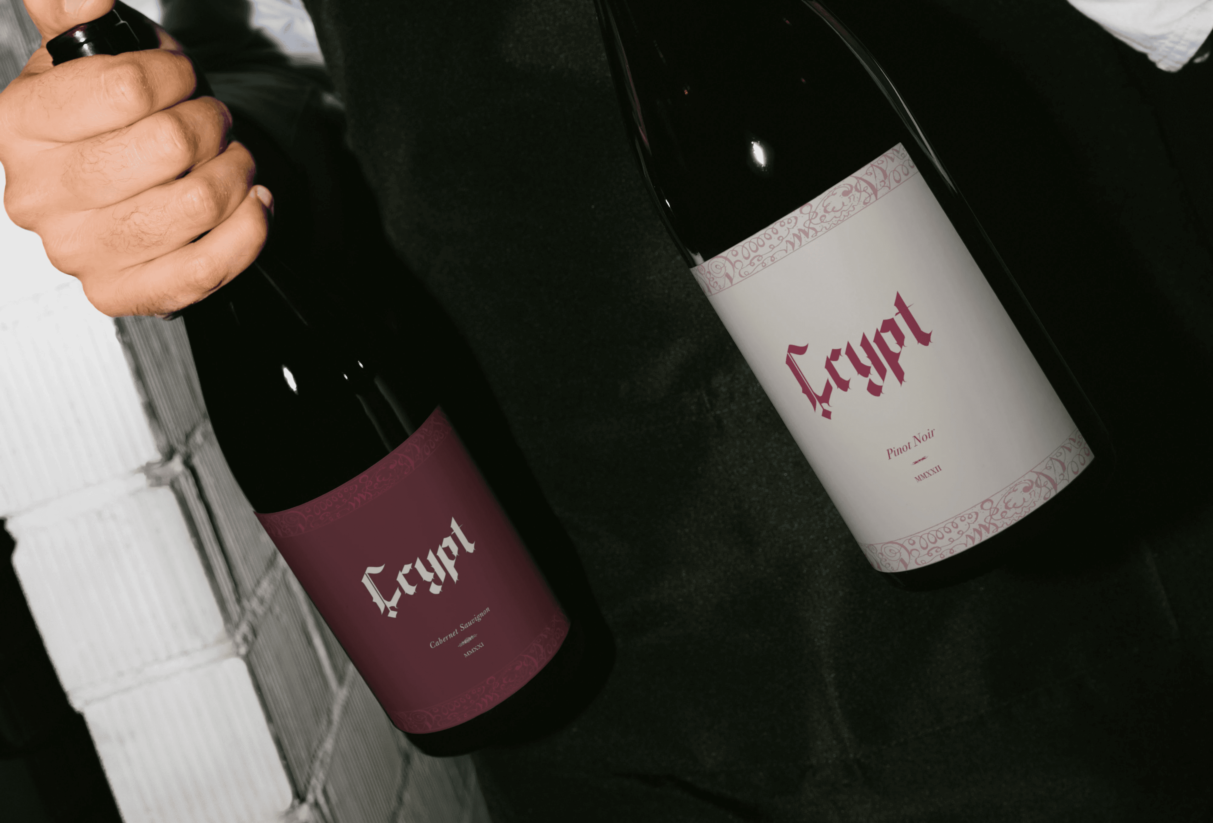 Hand holding waffle cone with three scoops of colorful pastel ice cream