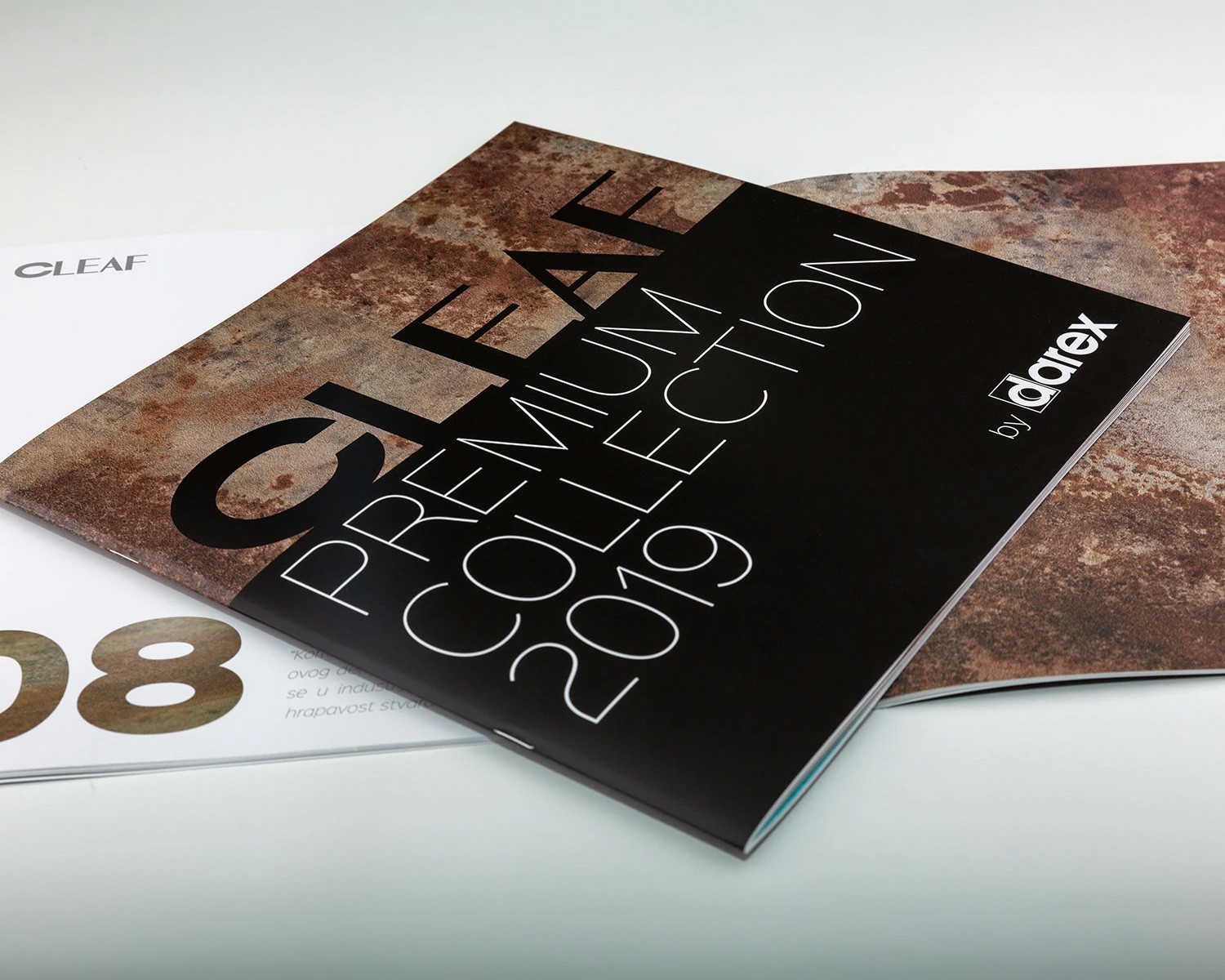 The CLEAF Premium Collection 2019: a printed catalogue with a rust-textured cover, photographed on a pale surface.