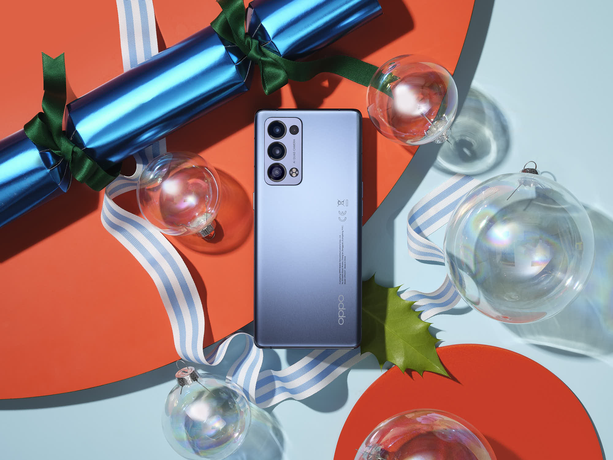 Smartphone with holiday decorations, featuring shiny blue color and multiple camera lenses.