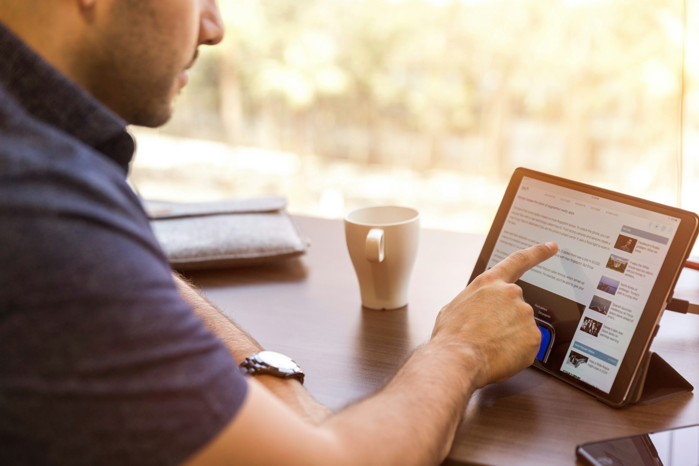Man Reading on Tablet - Genesys Alternatives