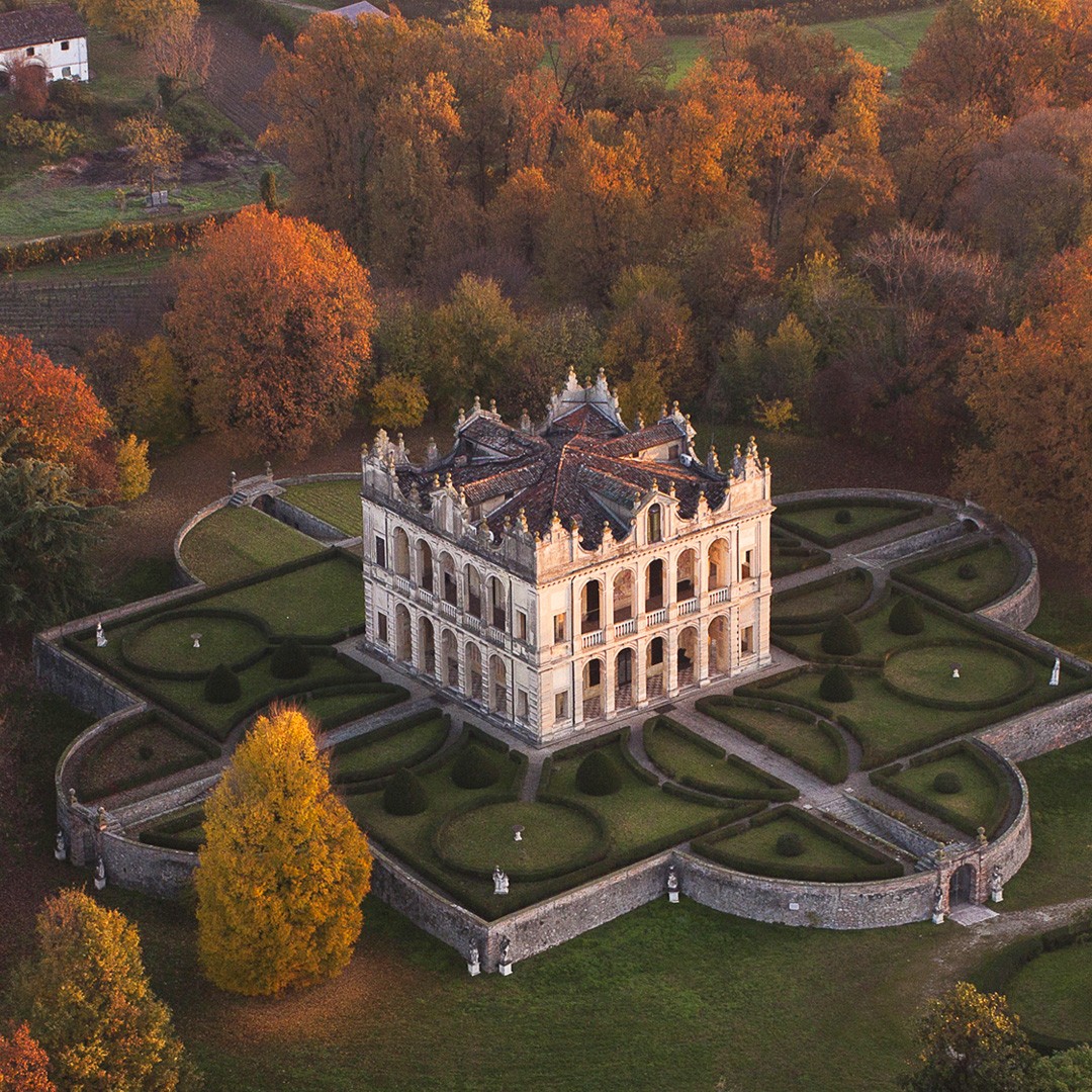 a couple of red cars parked next to each other