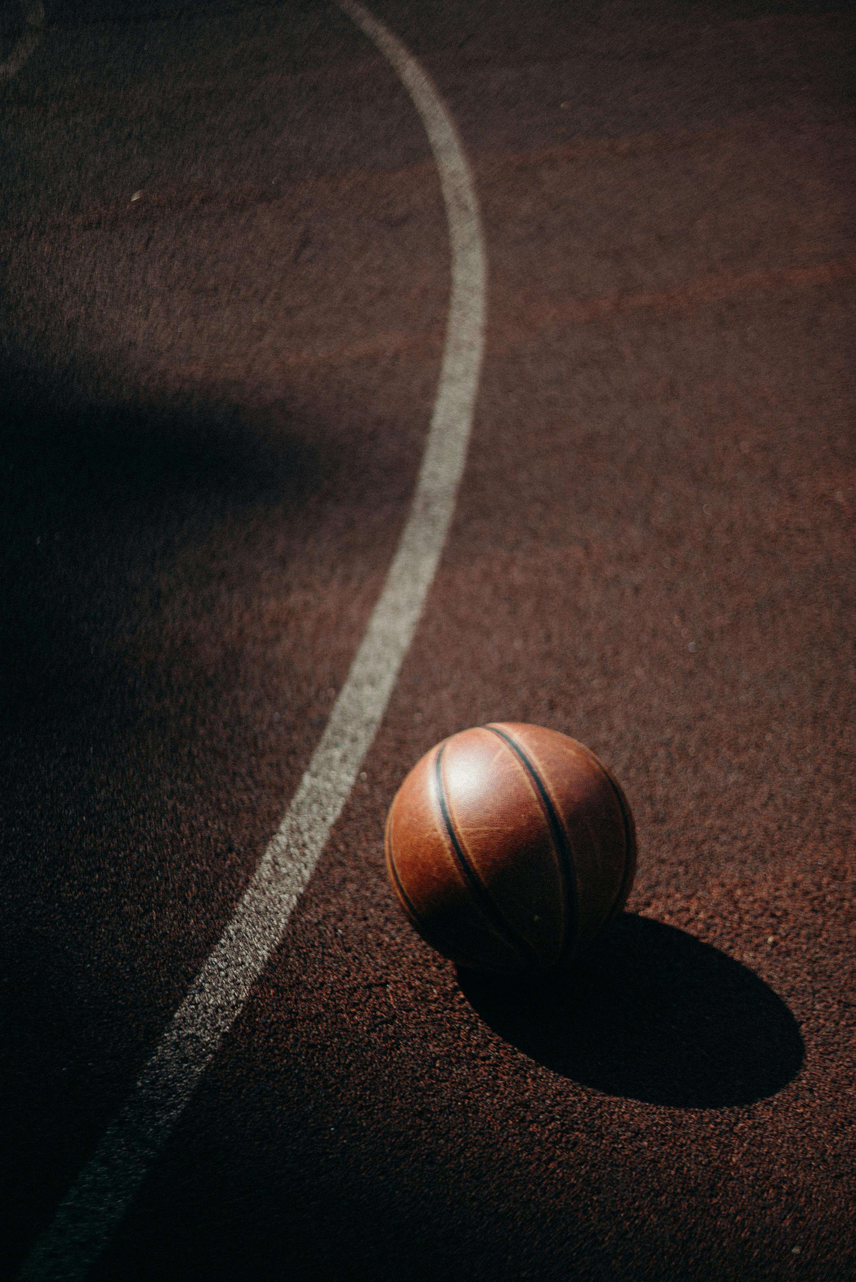 a basketball sitting alone on a court