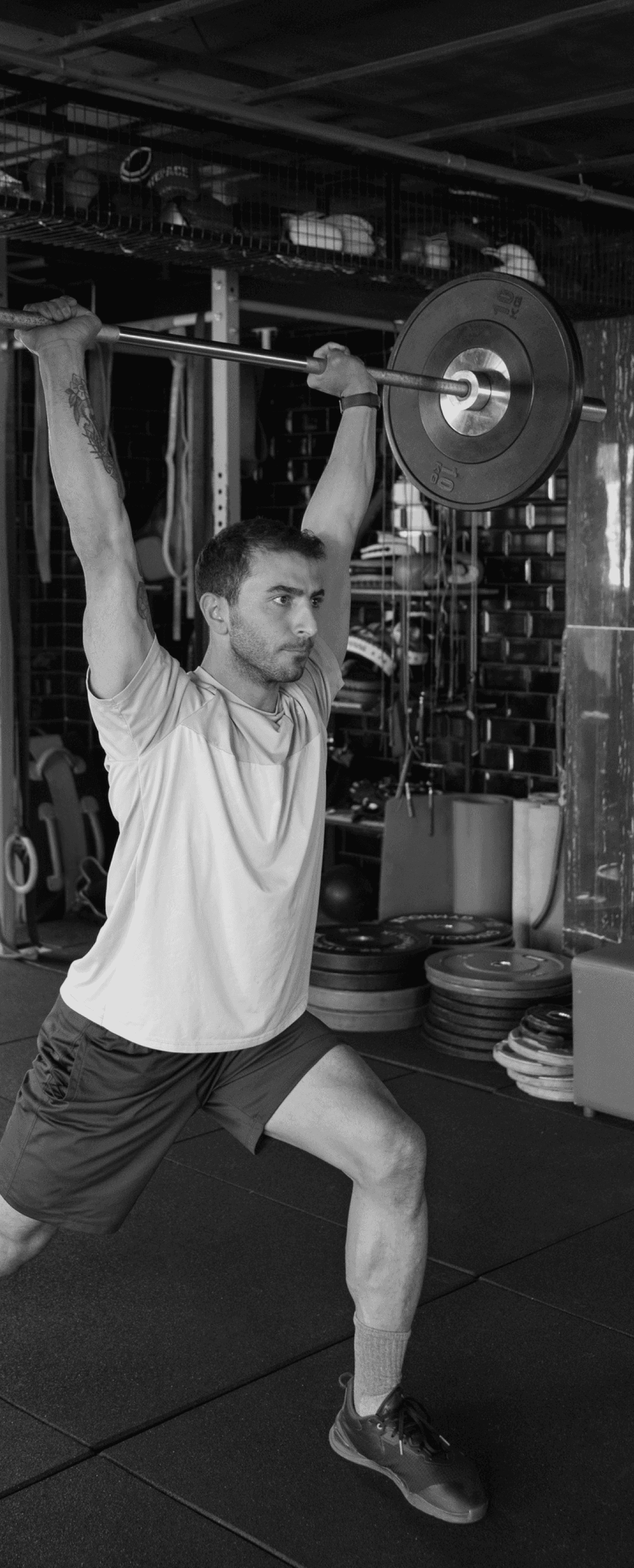 Fit man lifting weights for muscle toning