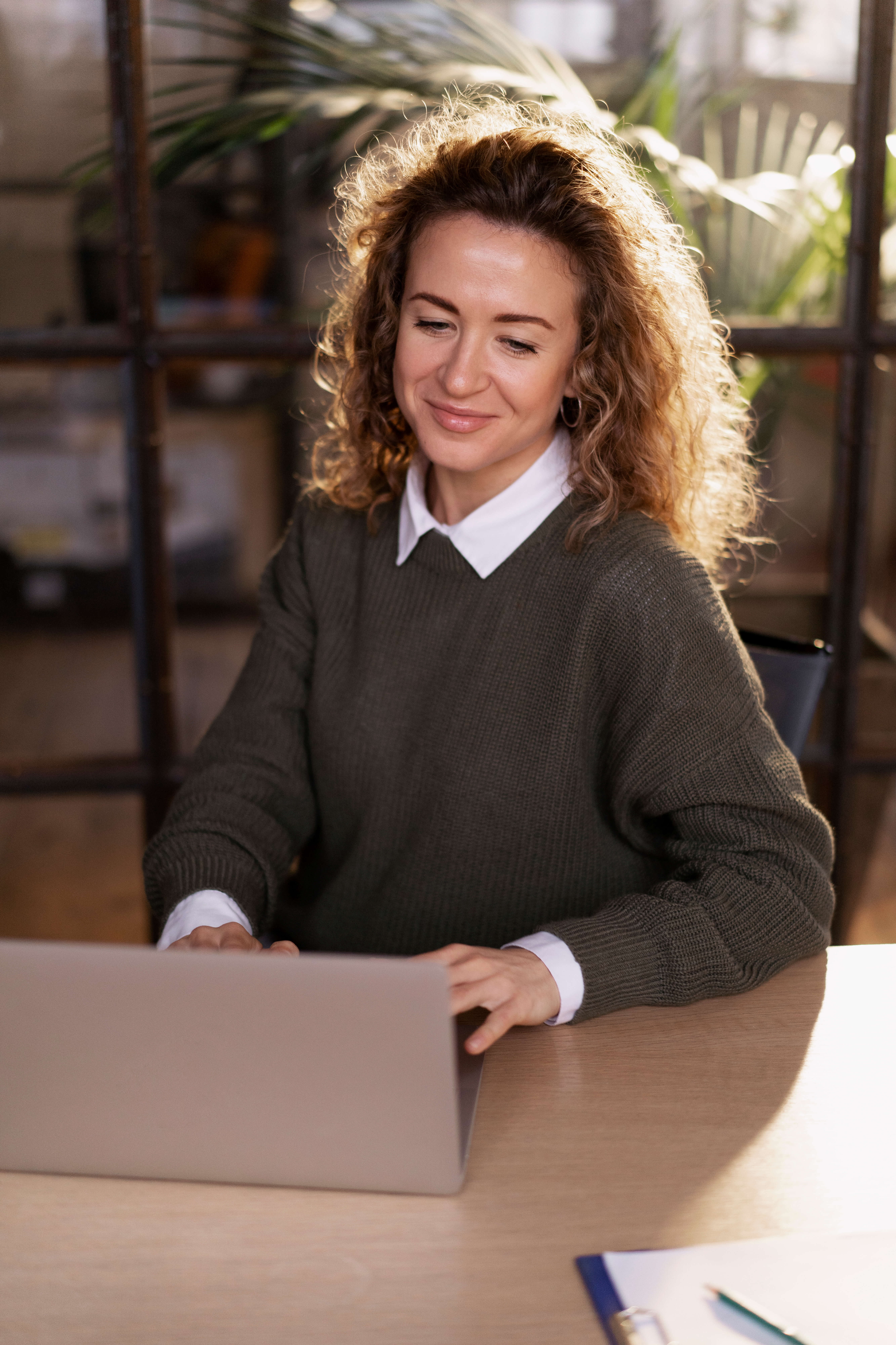 A lady in brown with a laptop