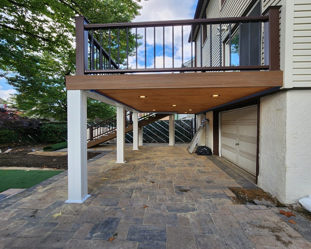 Custom Trex composite deck finished ceiling using Trex Rain Escape by Jewel Construction in Queens, NYC