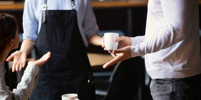 An FnB staff listening to customer complaints