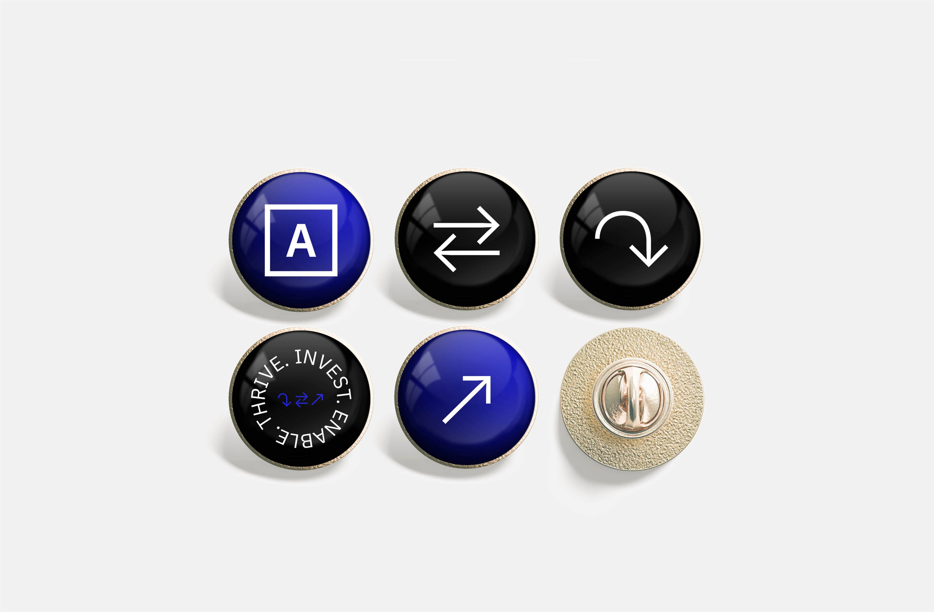Collection of blue and black pins featuring icons and empowerment text.