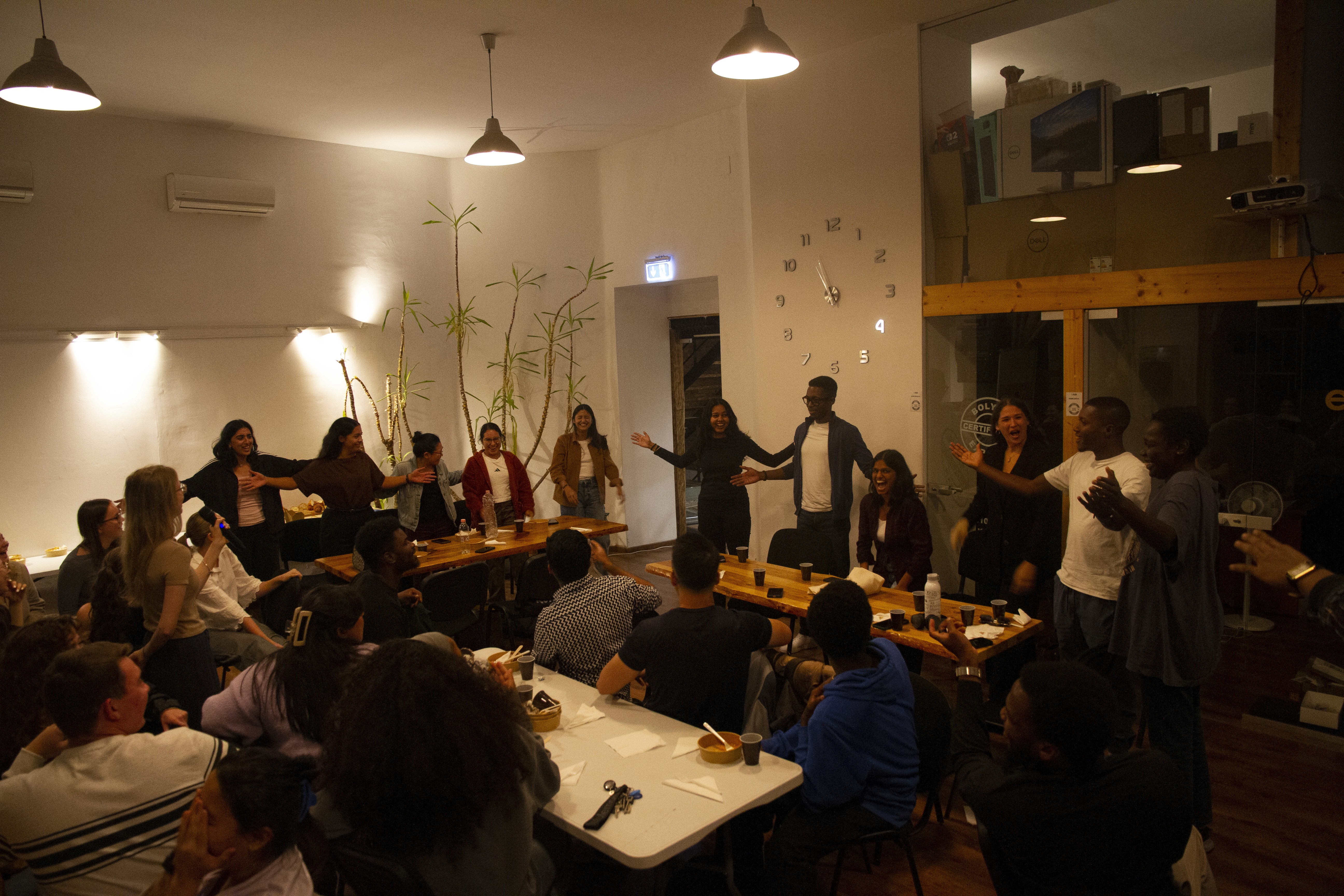 Free Framer Template - A group of professionals collaborating around a table in a modern office space with computers and creative decor.