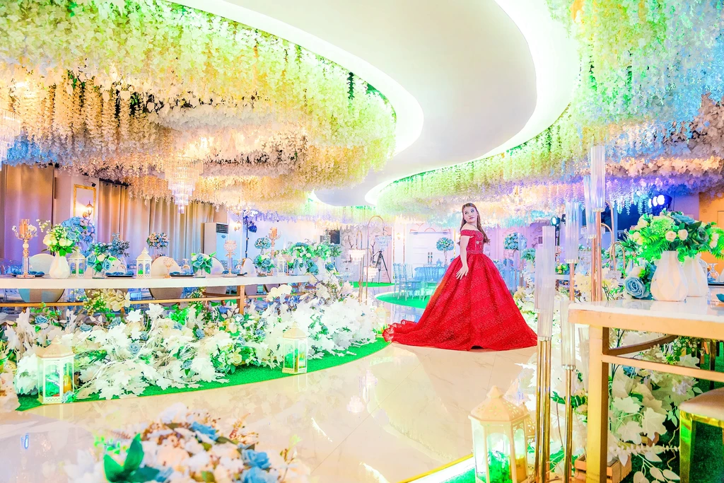 Debutante in a red gown by the arch and piano at Celestia Hall