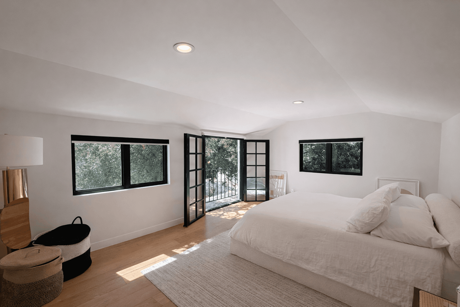 Modern living room with black leather sofas and tree-patterned rug