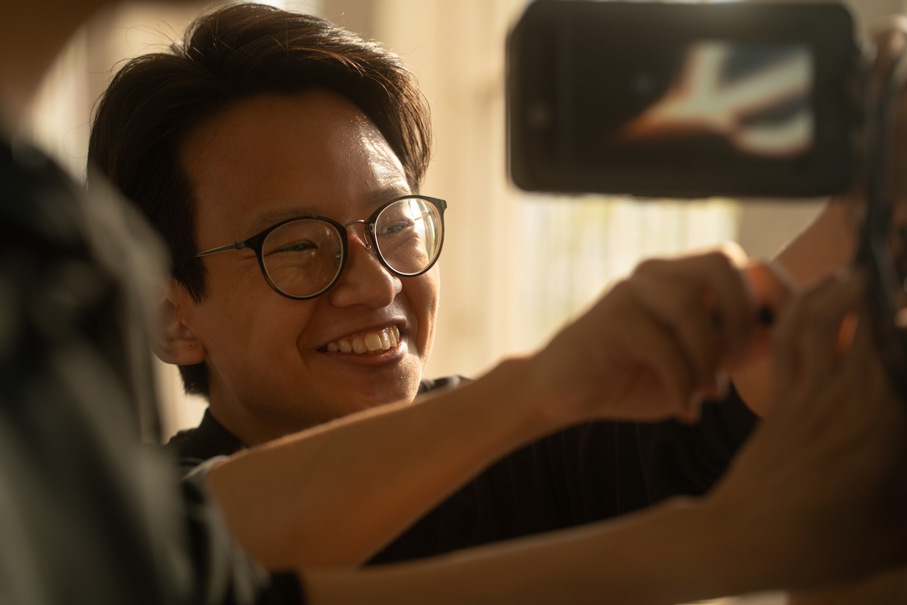 the camera operator is smiling under stress