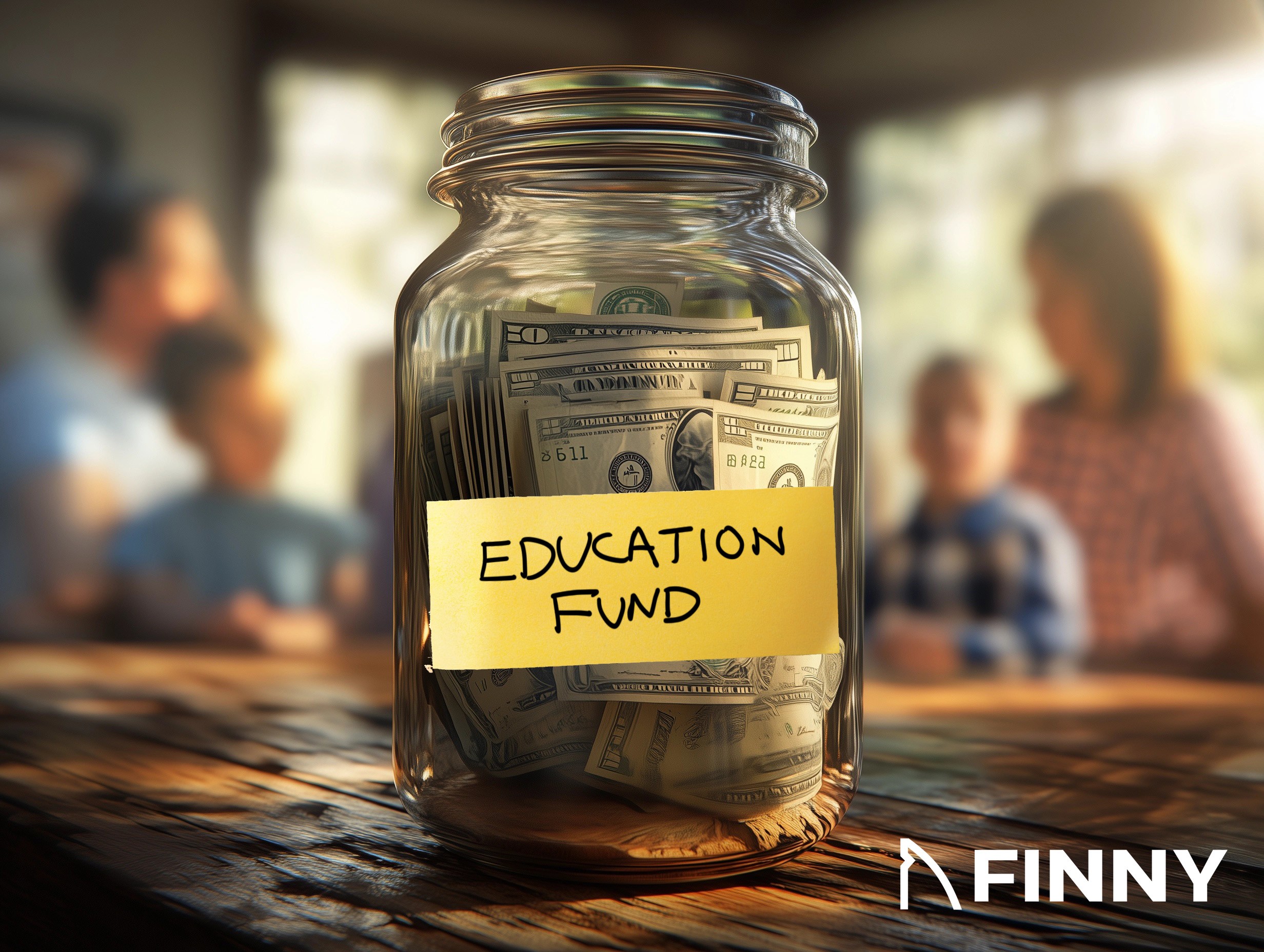 A glass jar labeled "Education Fund" filled with dollar bills sits on a wooden table. The blurred background shows a family scene, symbolizing saving for educational purposes. The FINNY logo is in the bottom-right corner.