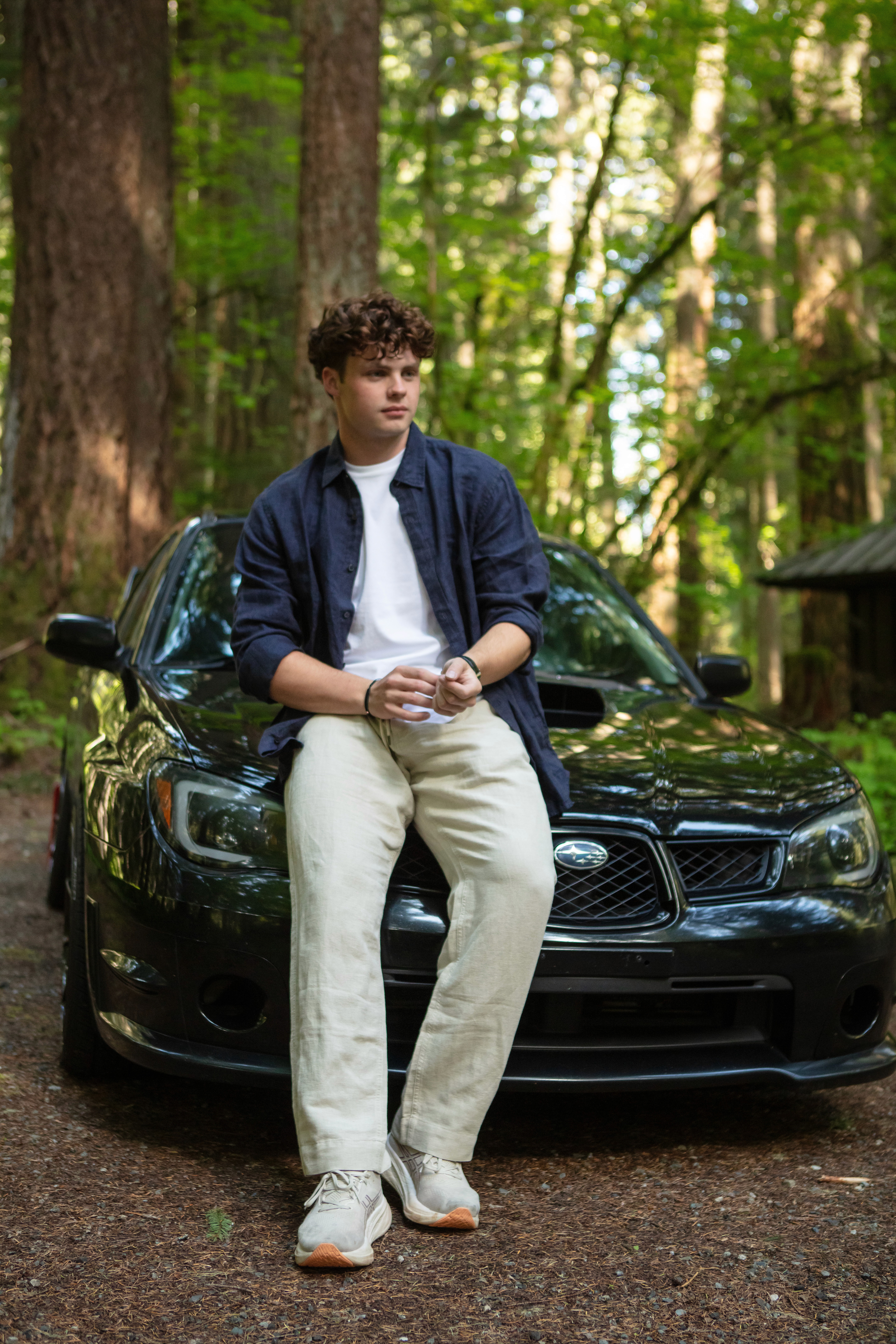 Modern home office setup with a monitor, ergonomic chair, keyboard, and indoor plants near a window with blinds.