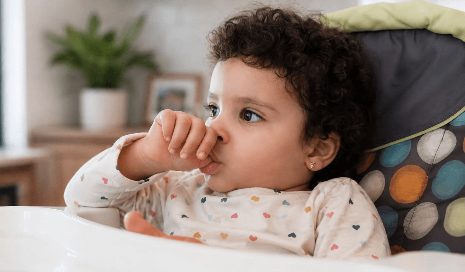 Toddler sucking their thumb, a common childhood habit that can contribute to gap teeth.&nbsp;