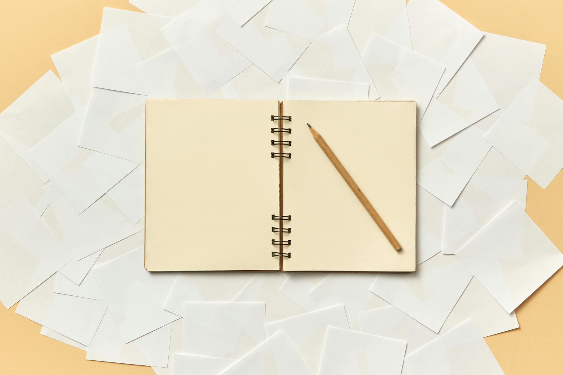 A diverse group of teachers sitting in a circle of chairs, taking notes during a professional development workshop.