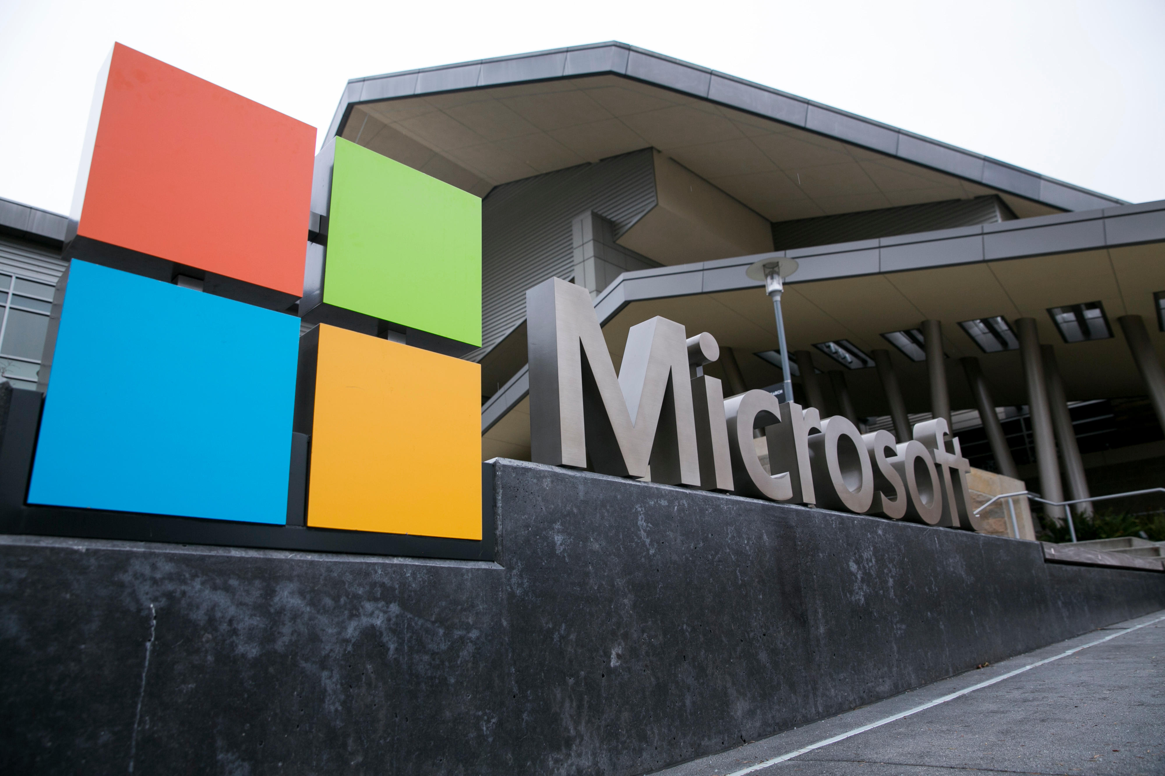 Microsoft building with large, colorful square logo in red, green, blue, and yellow. The modern architecture features a sleek, angular design.